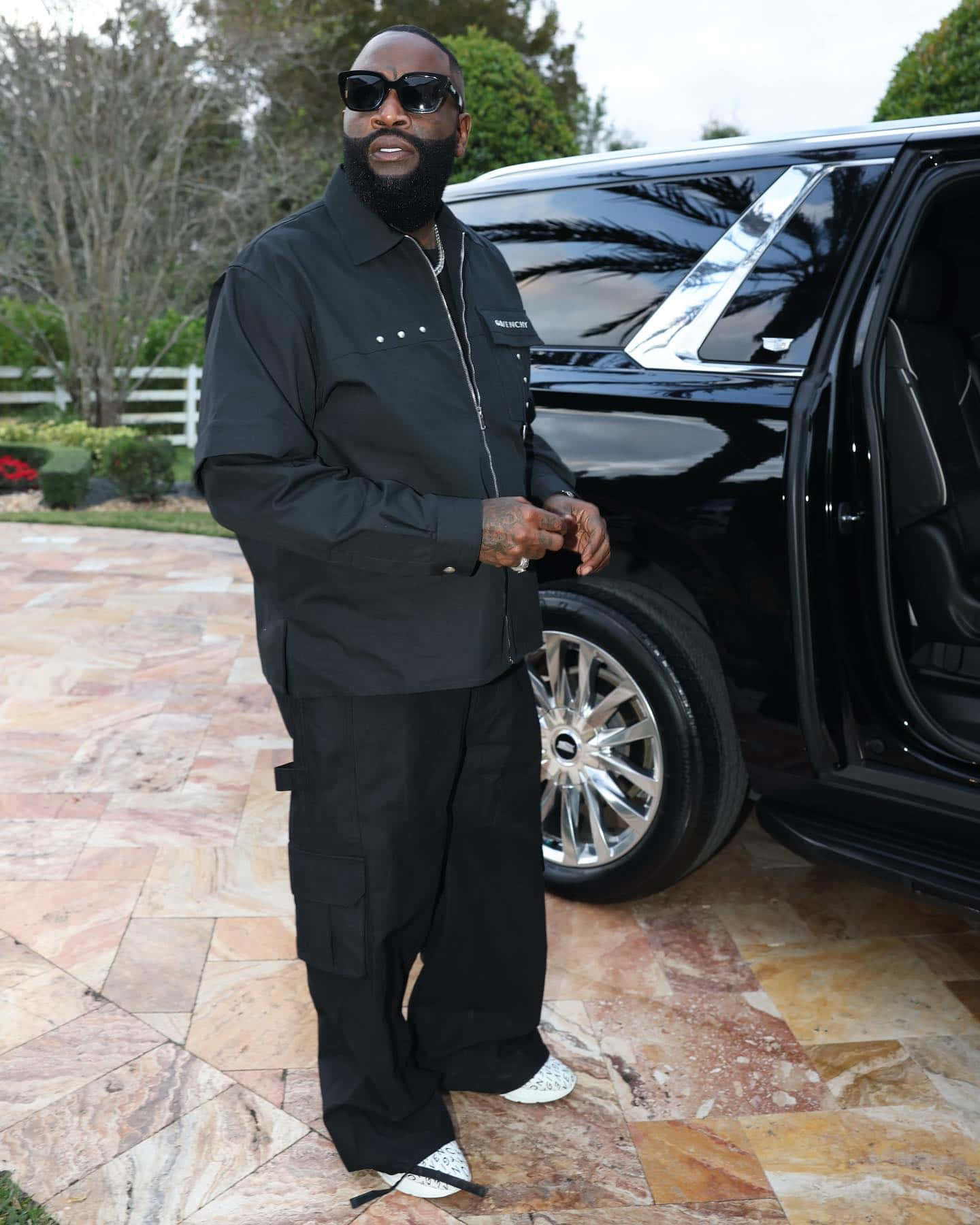 Rick Ross Standing Beside Luxury Car Wallpaper