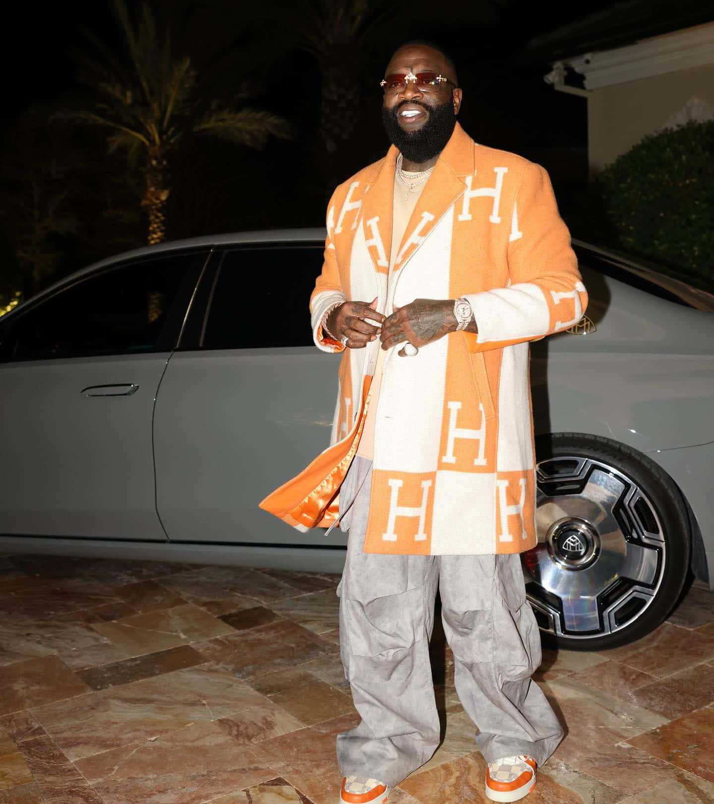 Rick Ross Stylish Outfit Beside Car Wallpaper