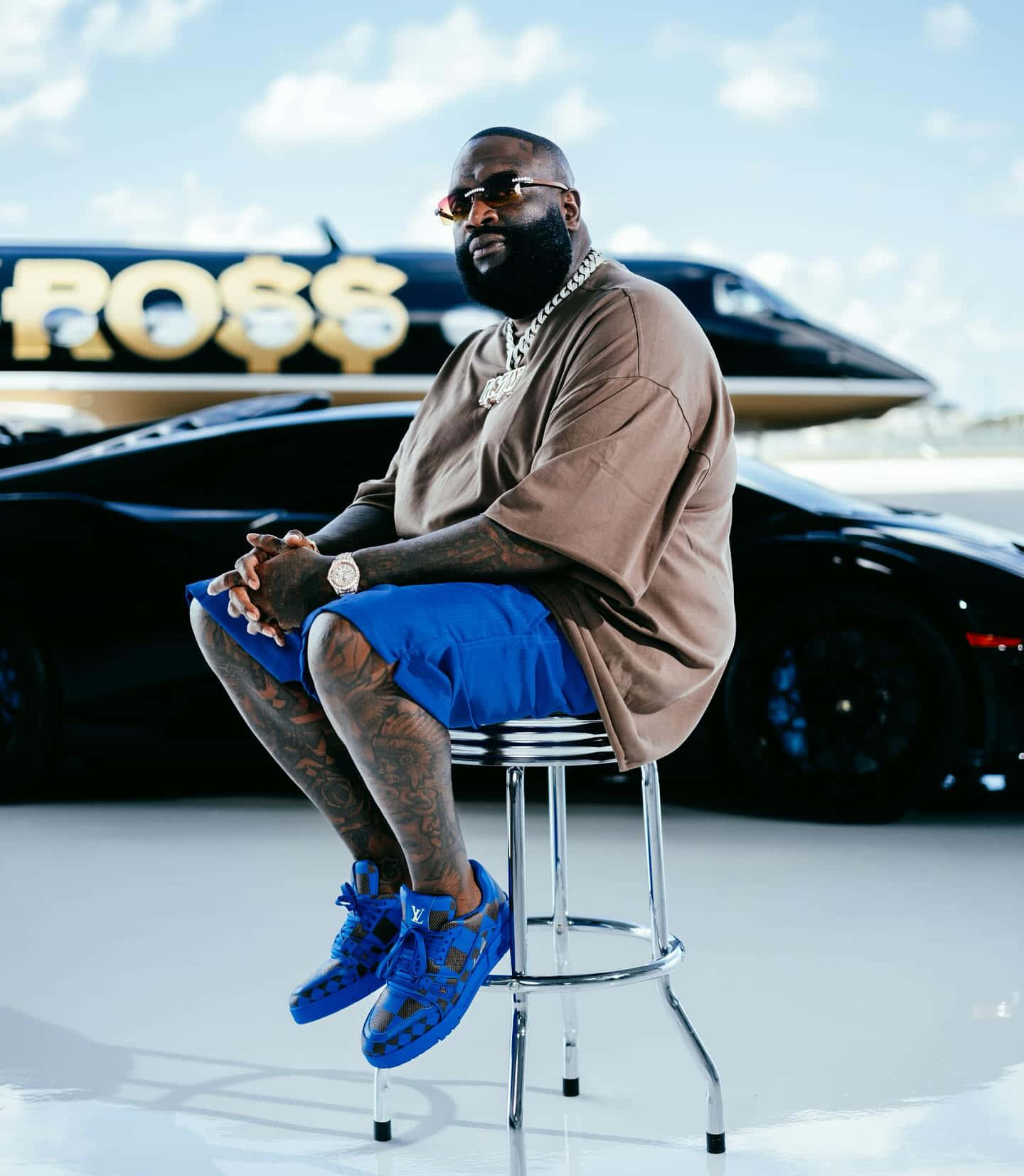 Rick Ross Stylish Pose With Cars And Jet Wallpaper