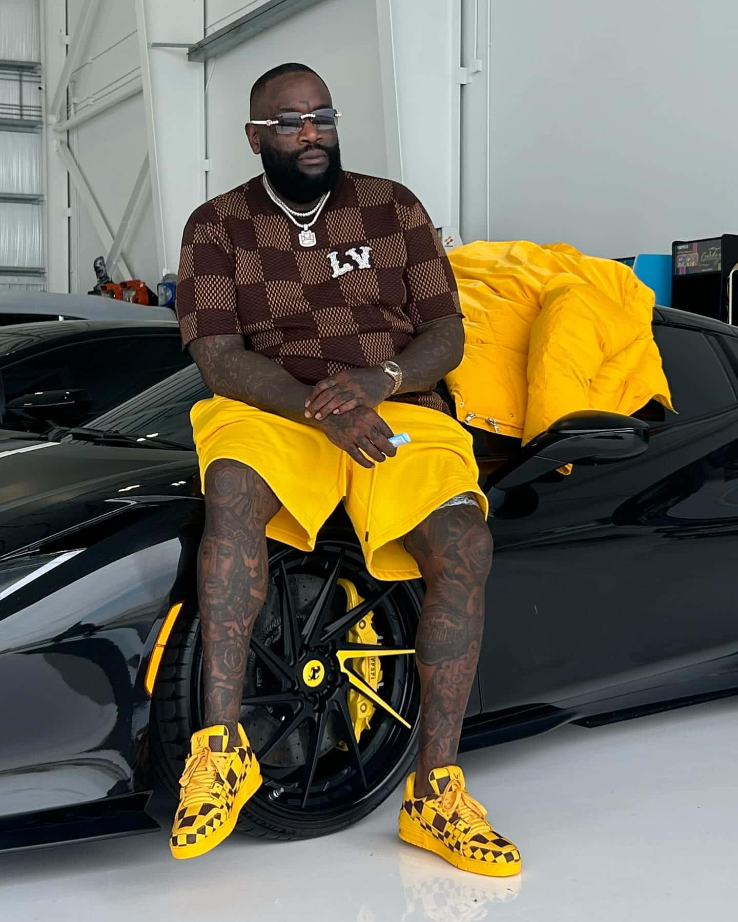 Rick Ross Stylish Pose With Luxury Car Wallpaper