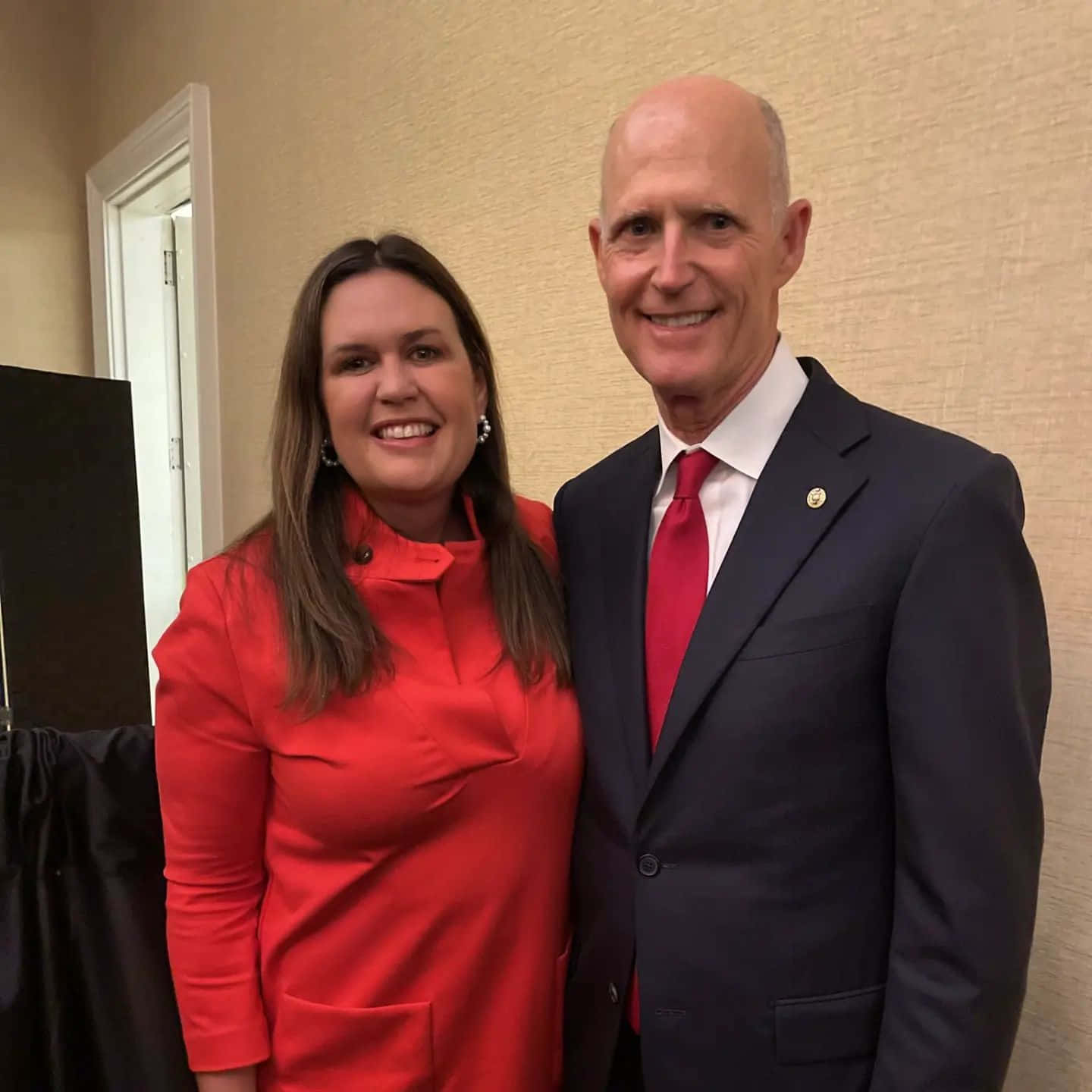 Former Florida Governor Rick Scott and former White House Press Secretary Sarah Huckabee Sanders in a friendly meeting. Wallpaper