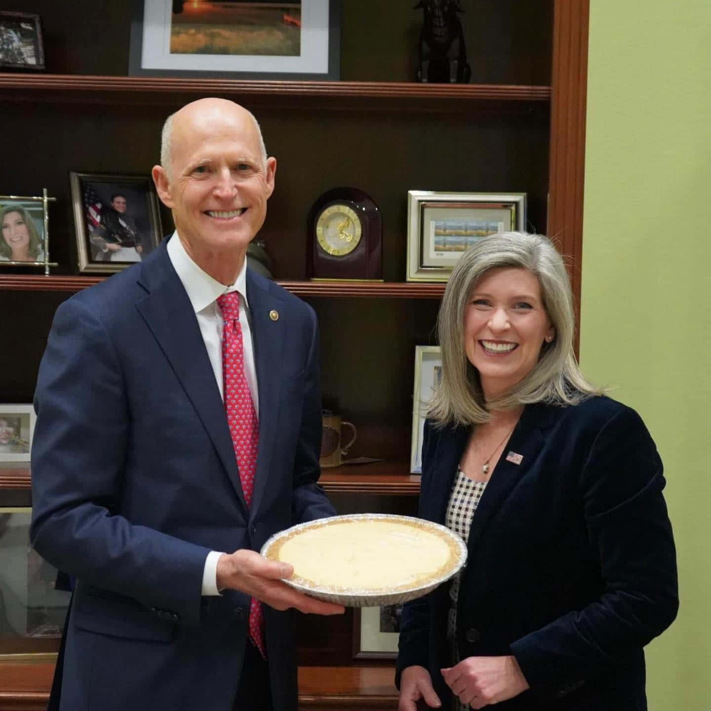 Rick Scott Giving Pie To Senator Joni Ernst Wallpaper