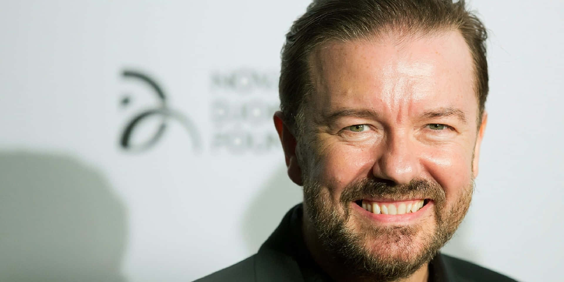 Ricky Gervais – Iconic Comedic Genius Wallpaper