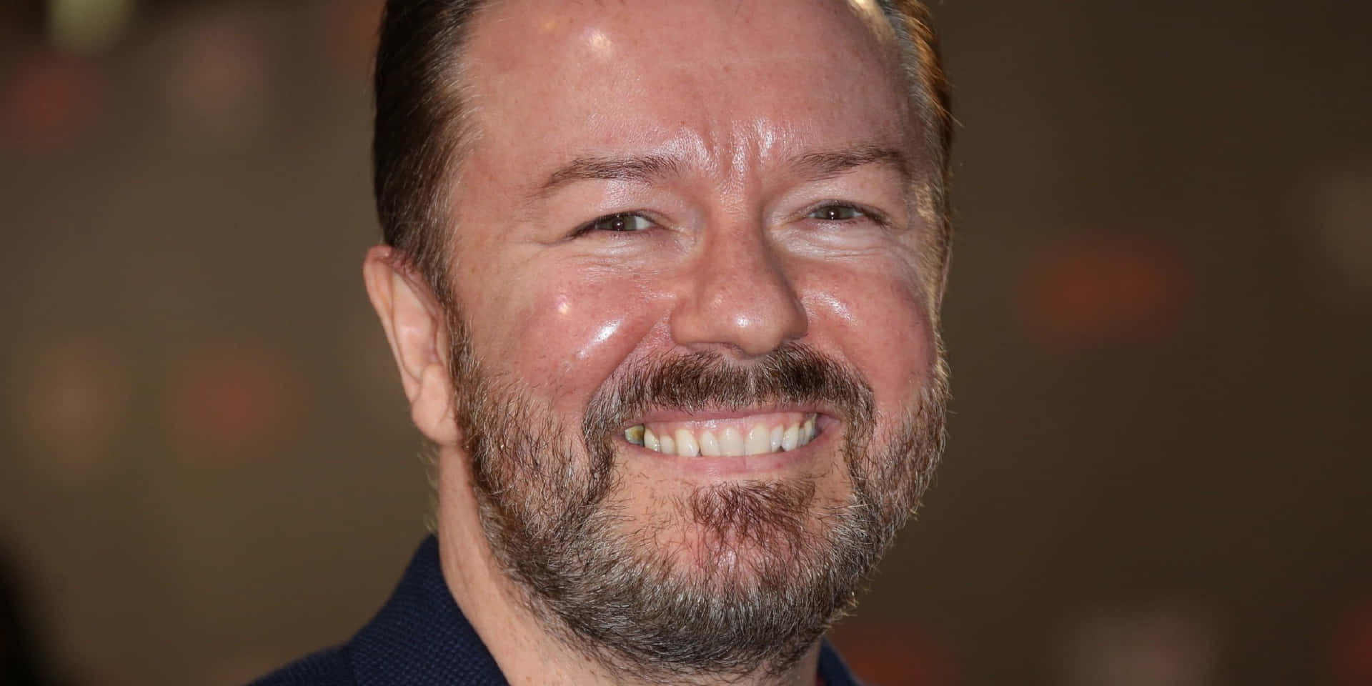Comedian Ricky Gervais Performing on Stage" Wallpaper