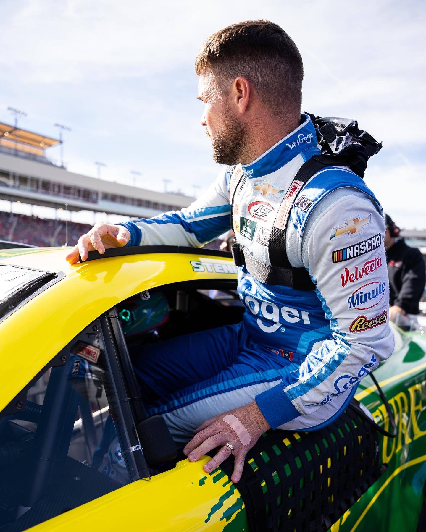 Ricky Stenhouse Jr. exiting his race car at a NASCAR event. Wallpaper