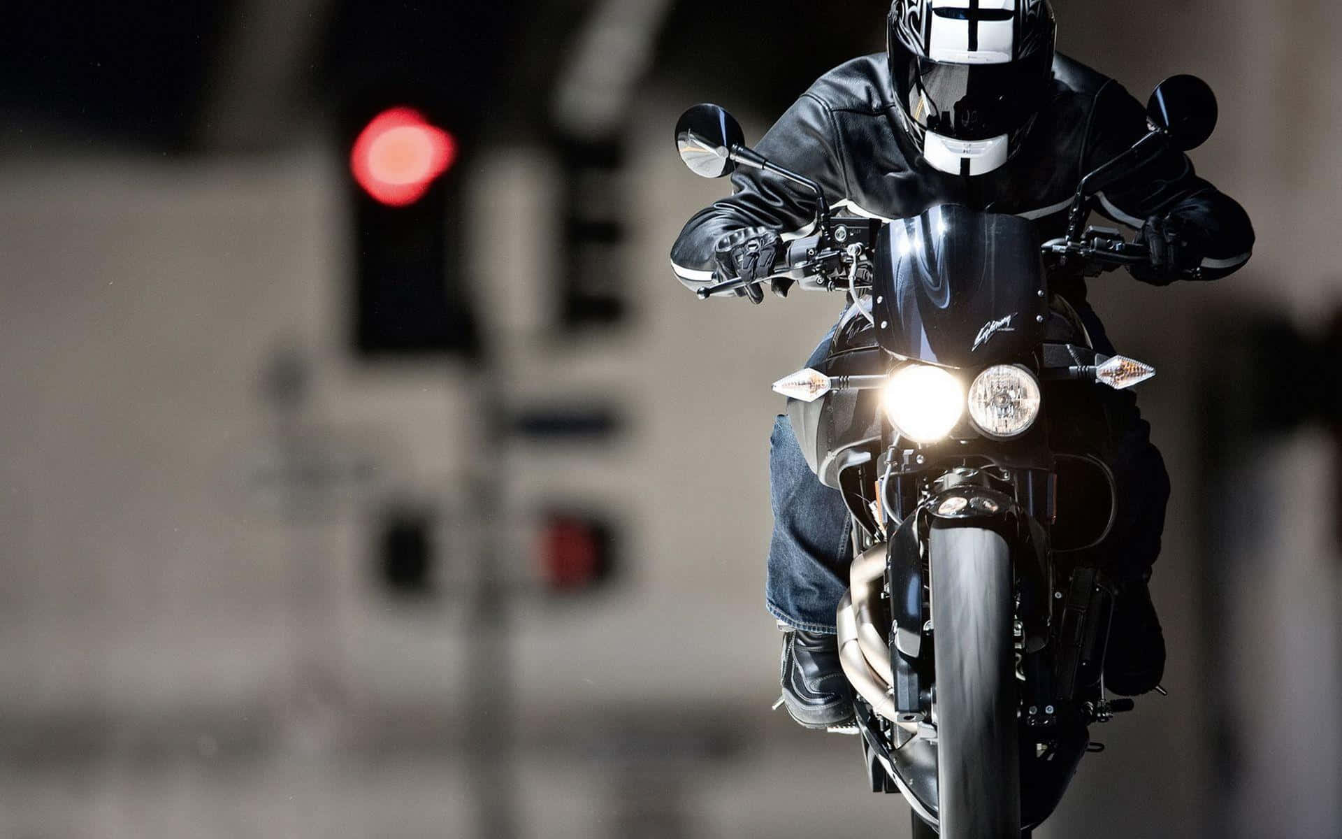 A Person Riding A Motorcycle At Night