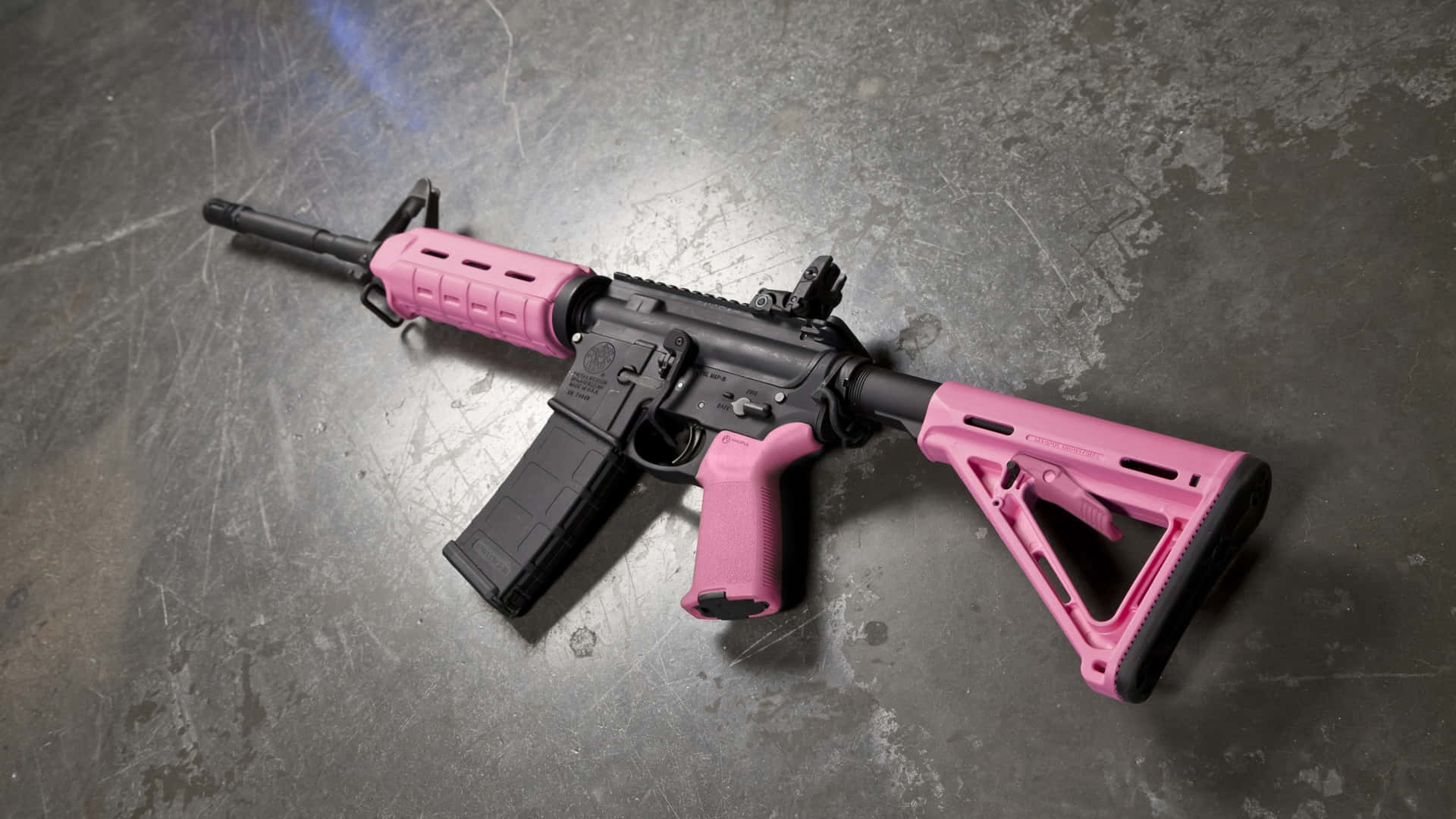 A Pink Ar-15 Rifle On A Concrete Surface