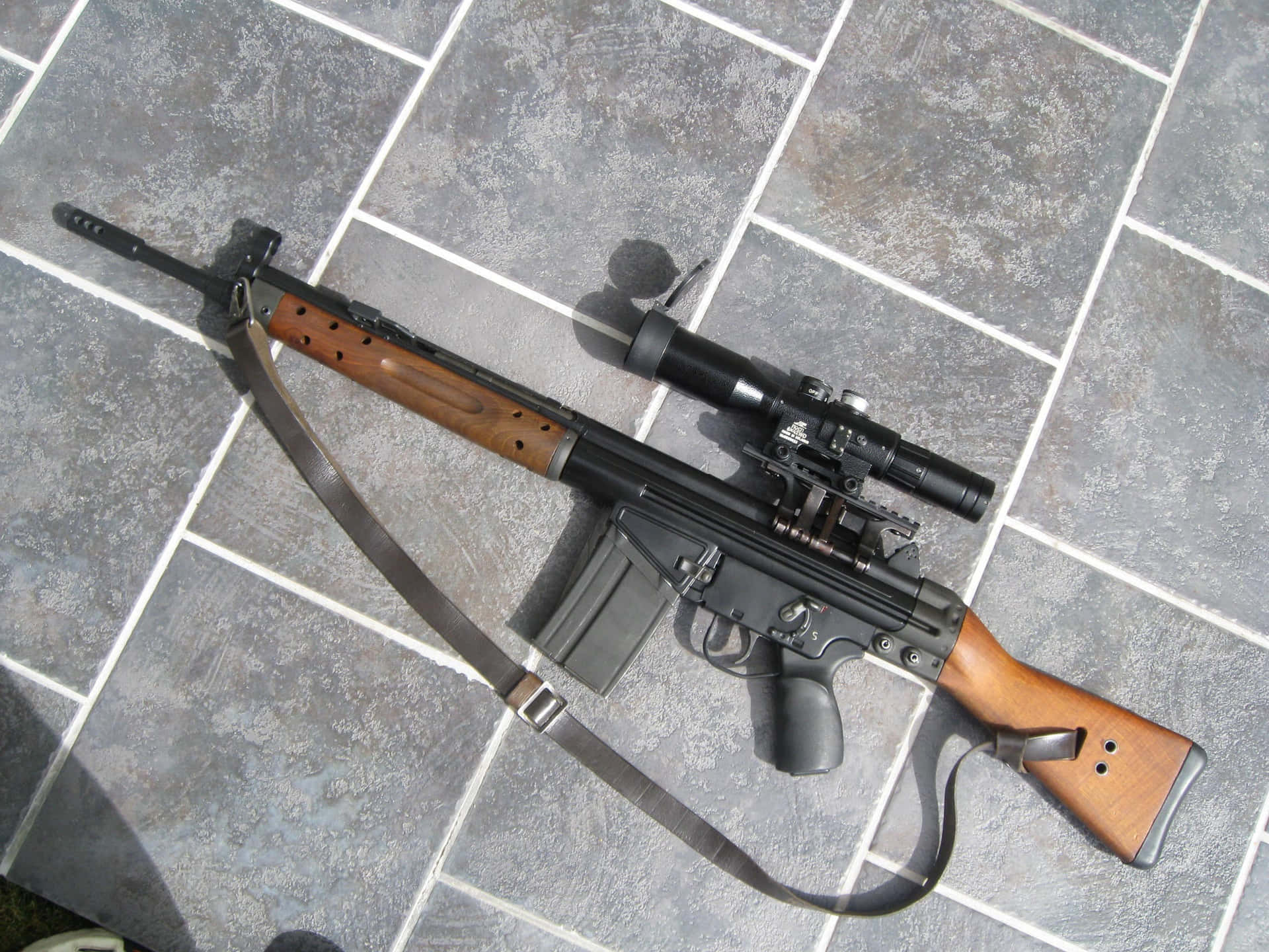 A Rifle With A Scope And A Wooden Handle