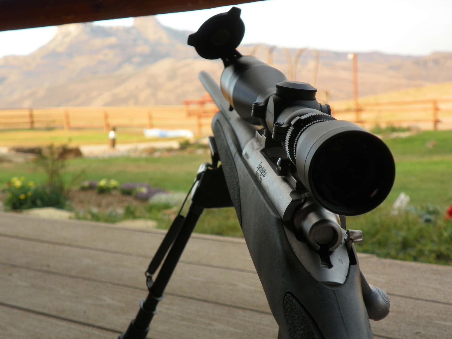 Rifle With Scope On Tripod Outdoors Wallpaper