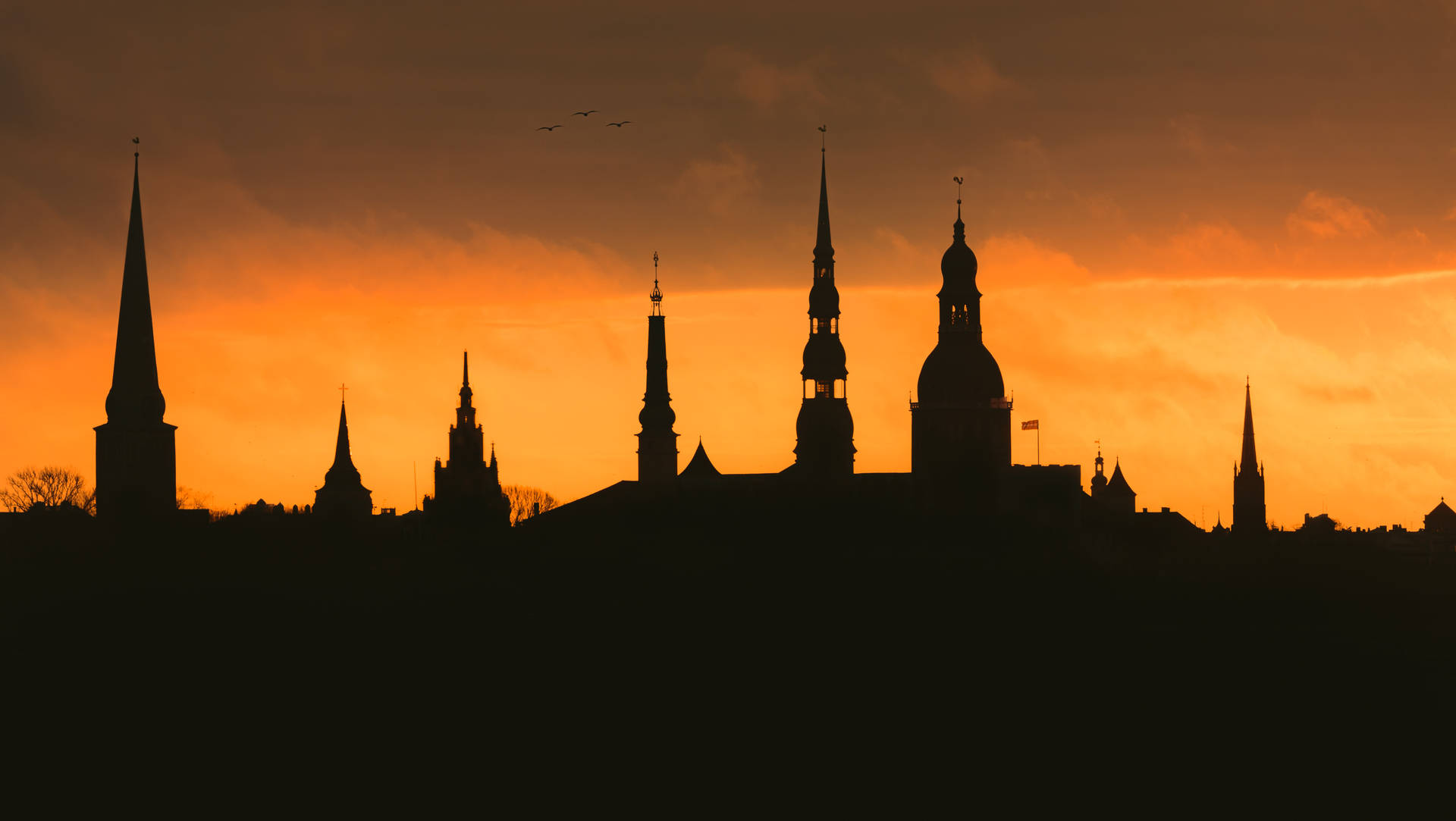 Riga's Steeples On A Sunset Wallpaper