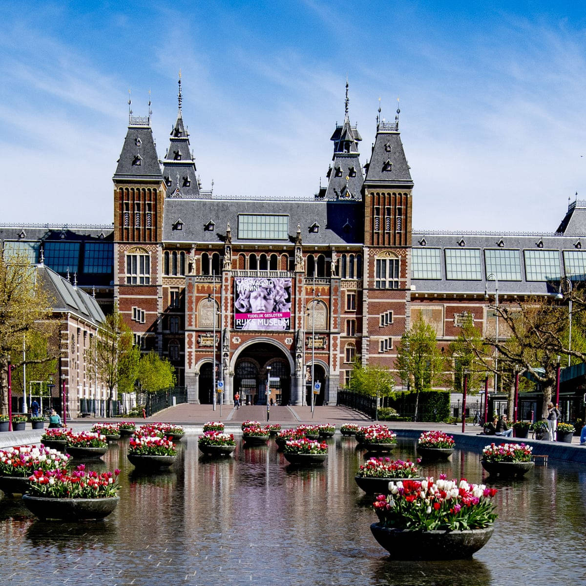 Rijksmuseum With Flowers In Pond Background