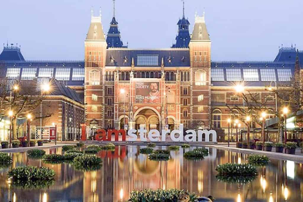 Rijksmuseum With Lights In The Evening Background