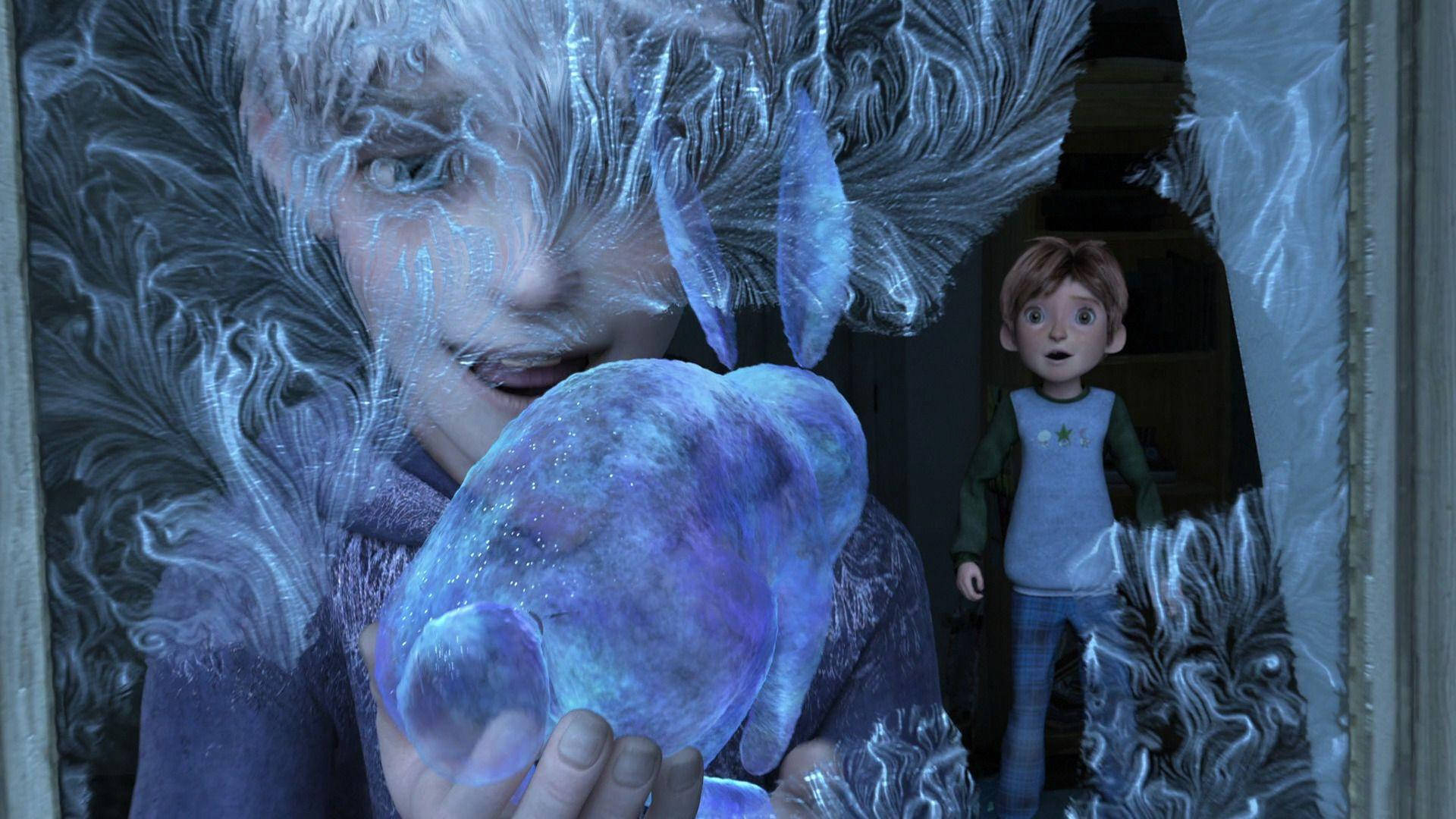 a boy is holding a frozen ball in his hands Wallpaper