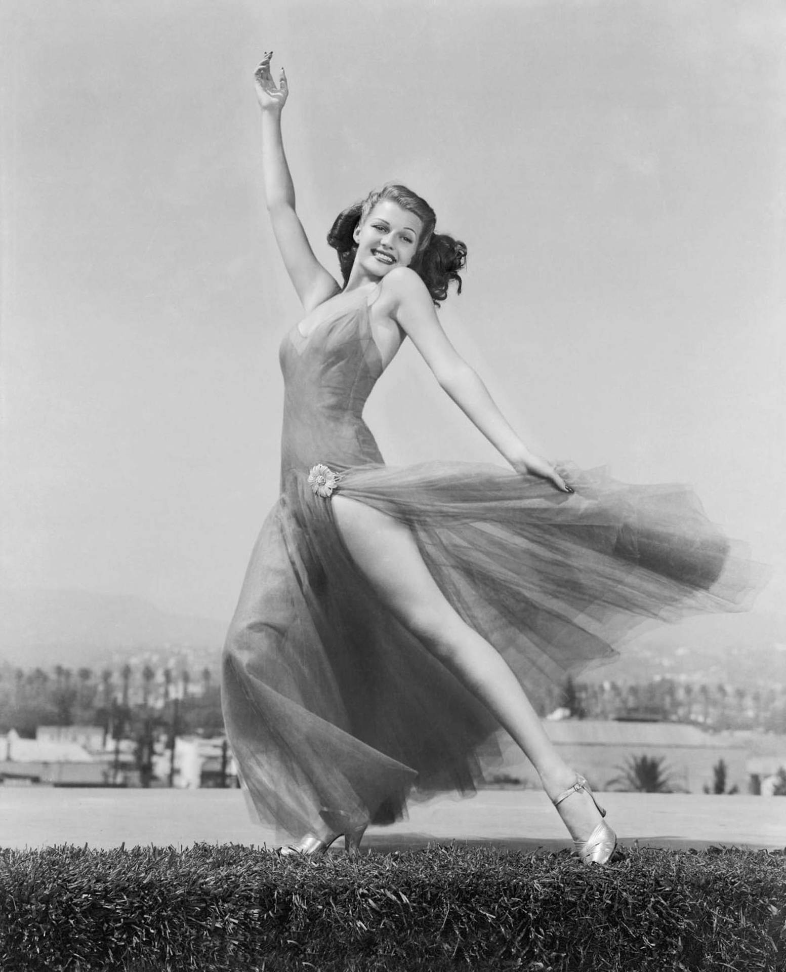 Rita Hayworth Dancing On Grass Wallpaper