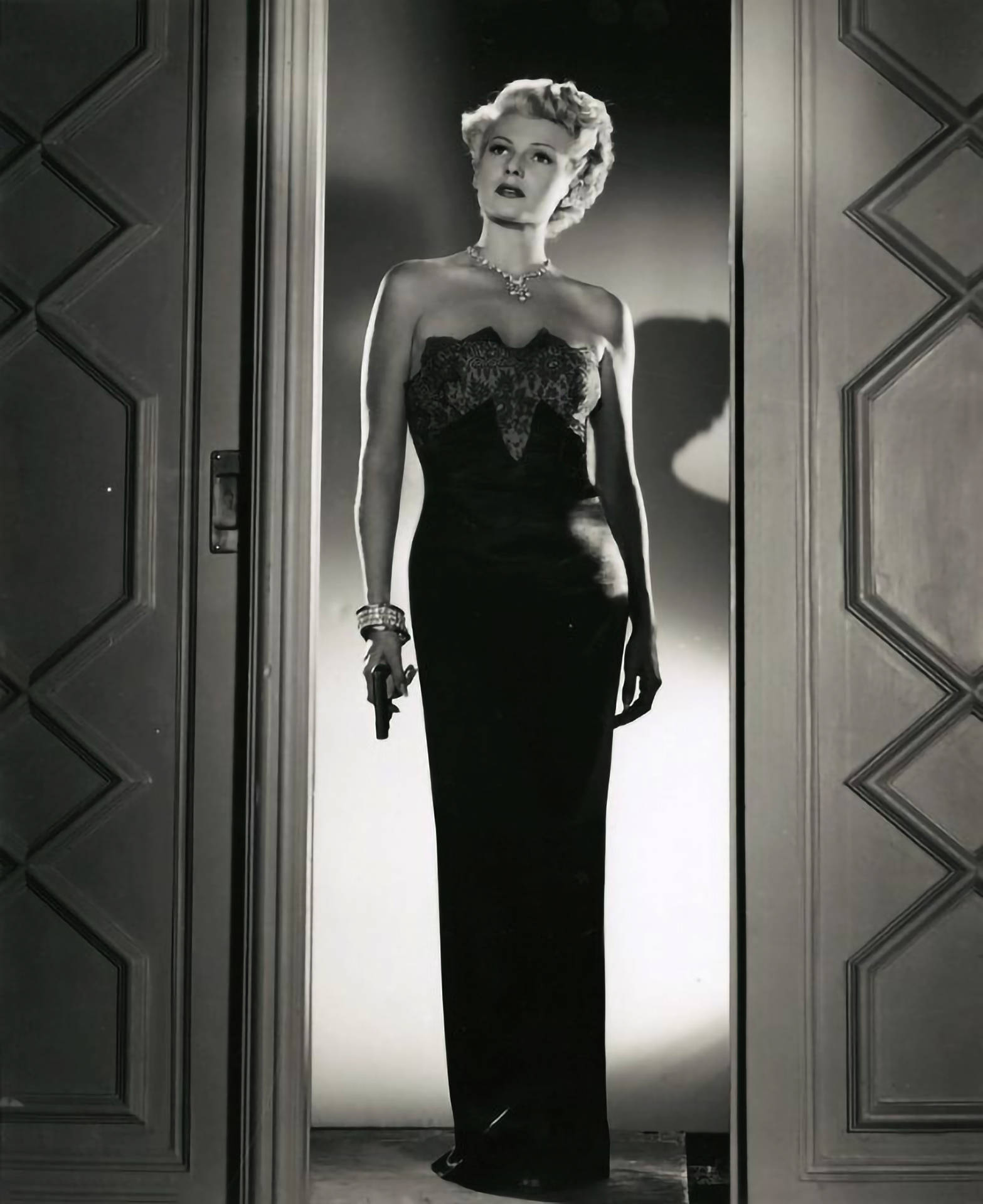 Rita Hayworth Holding A Gun Wallpaper