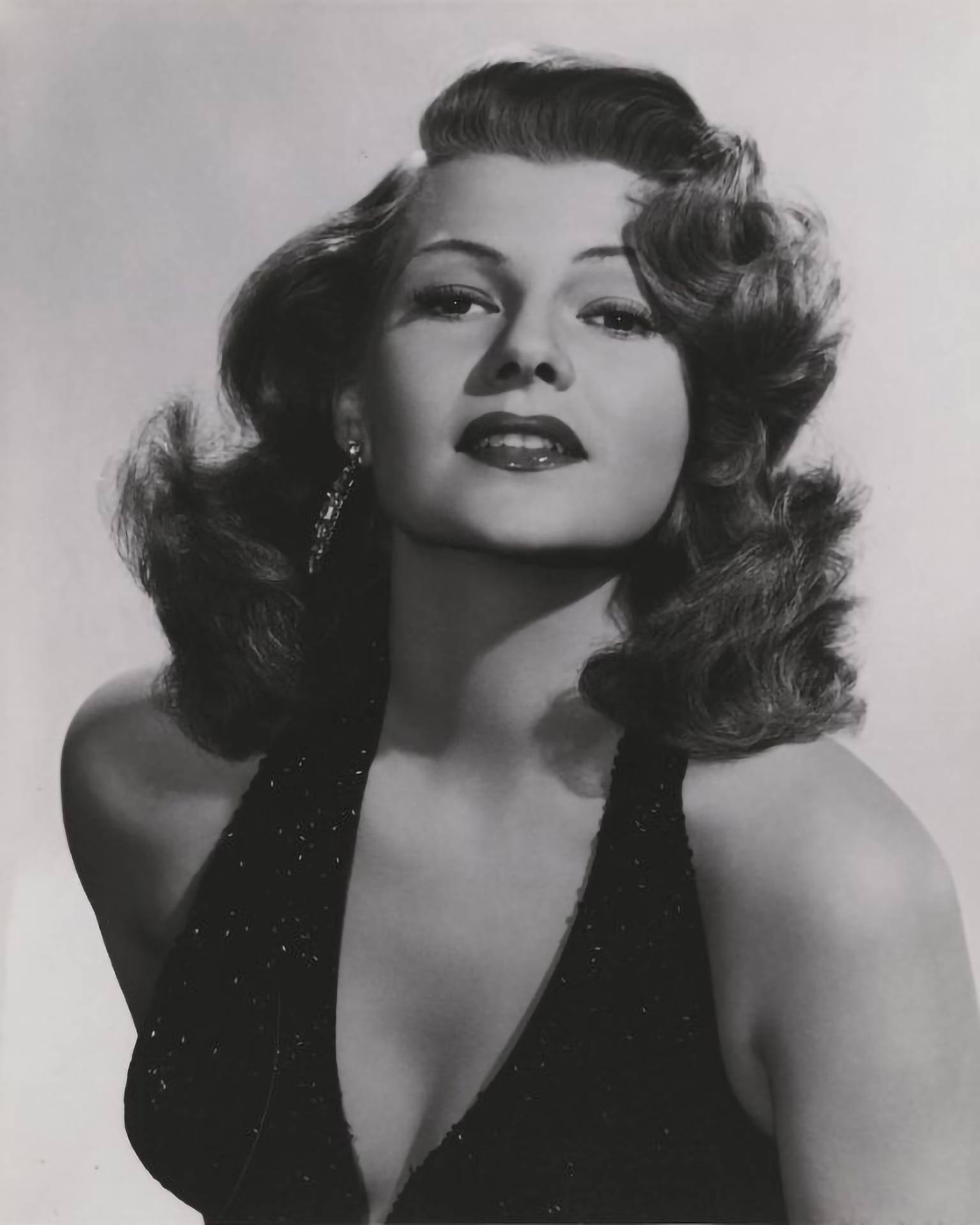 Caption: Classic Hollywood Icon Rita Hayworth in Sparkling Halter Dress Wallpaper