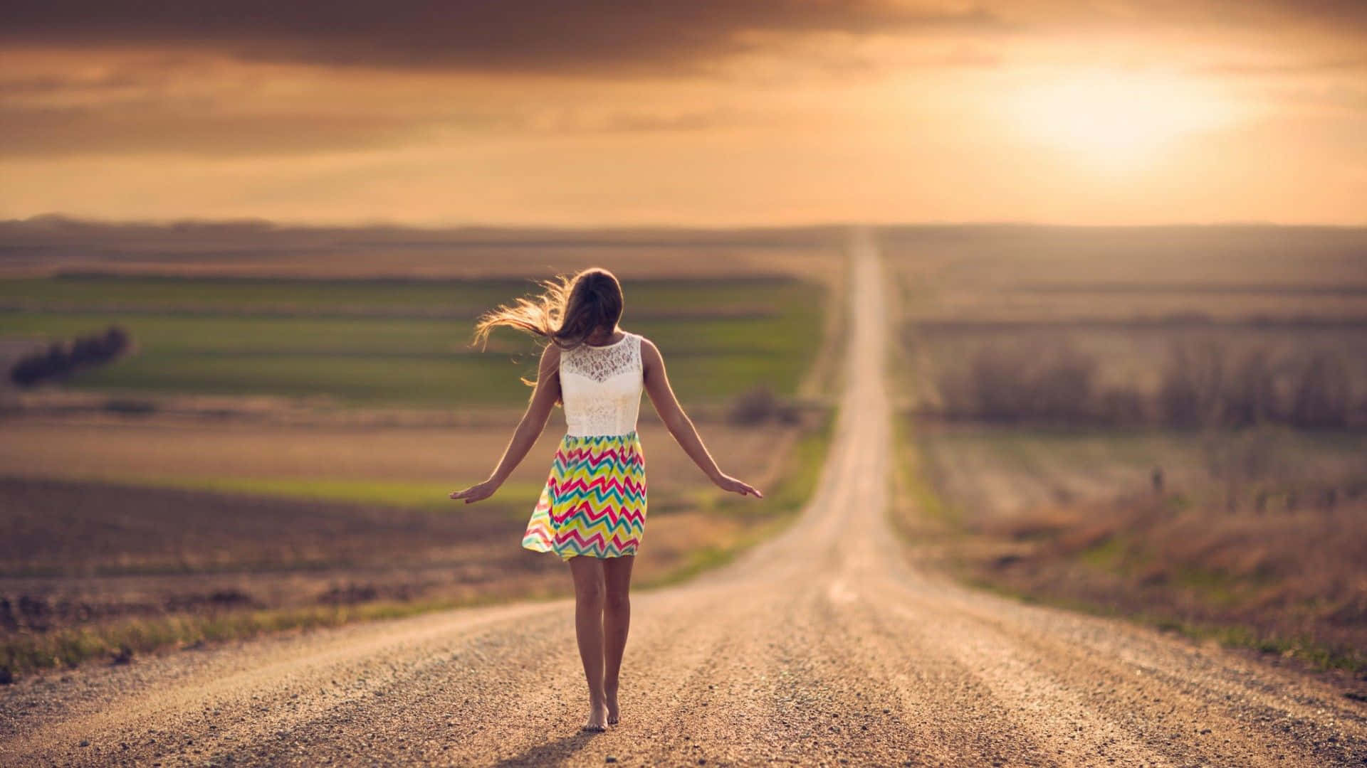 Woman Walking Down A Dirt Road Background