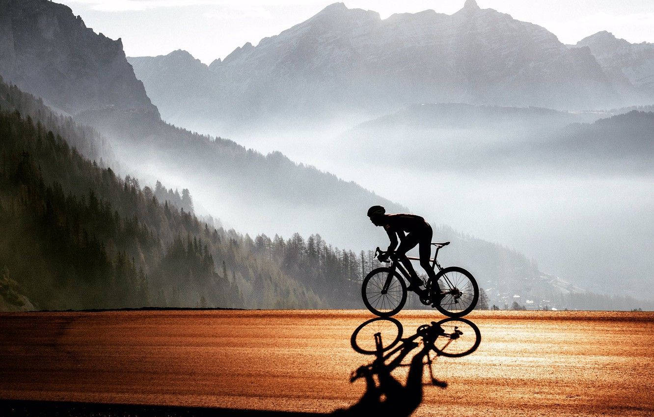 Road Bike Ride In Foggy Mountain Wallpaper