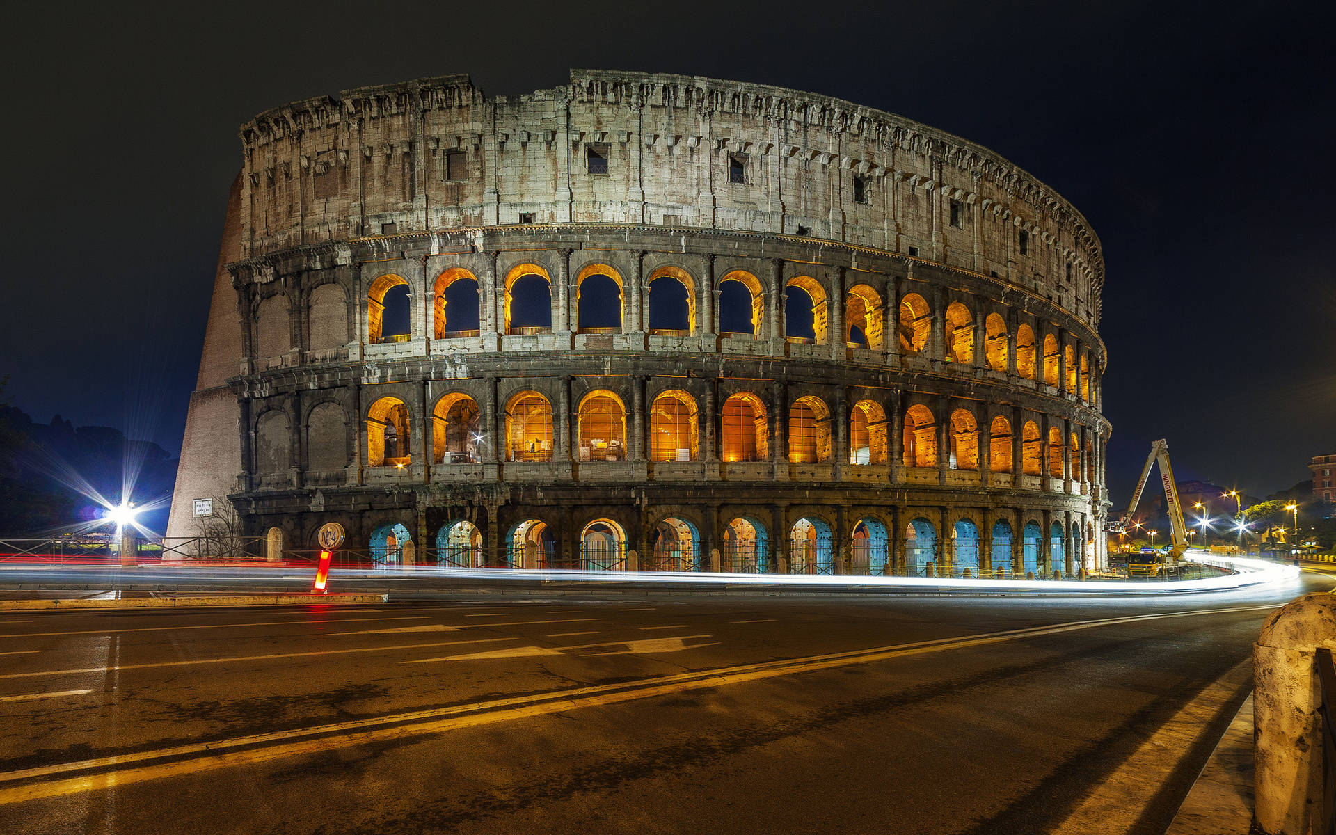 Road By The Colosseum At Night Wallpaper