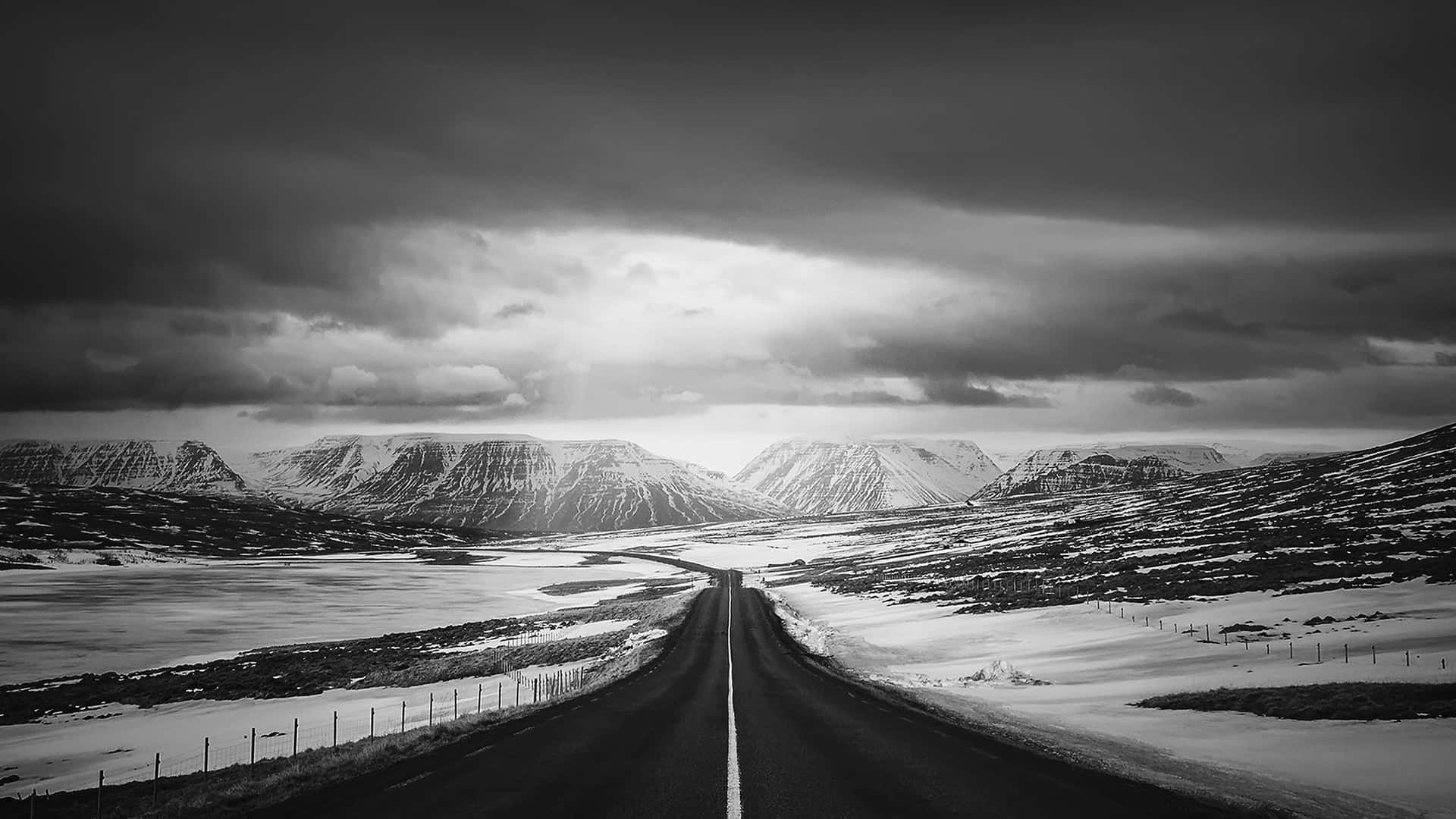 A Black And White Photo Of A Road In The Snow
