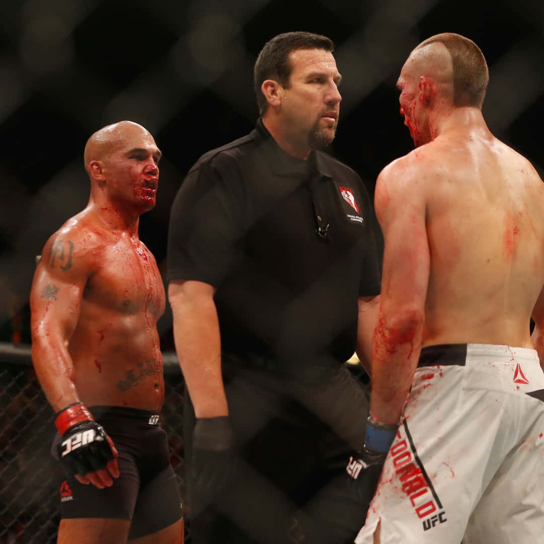 Robbie Lawler standing victorious against Rory MacDonald post their intense match at UFC 189. Wallpaper