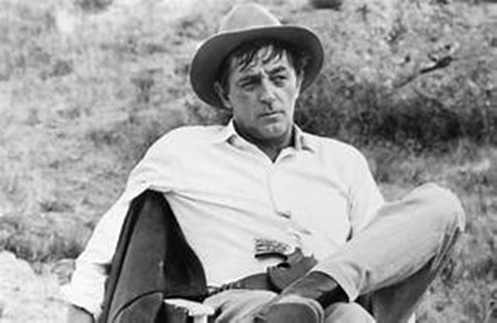 "Iconic Actor Robert Mitchum in Serene Forest Immersion" Wallpaper