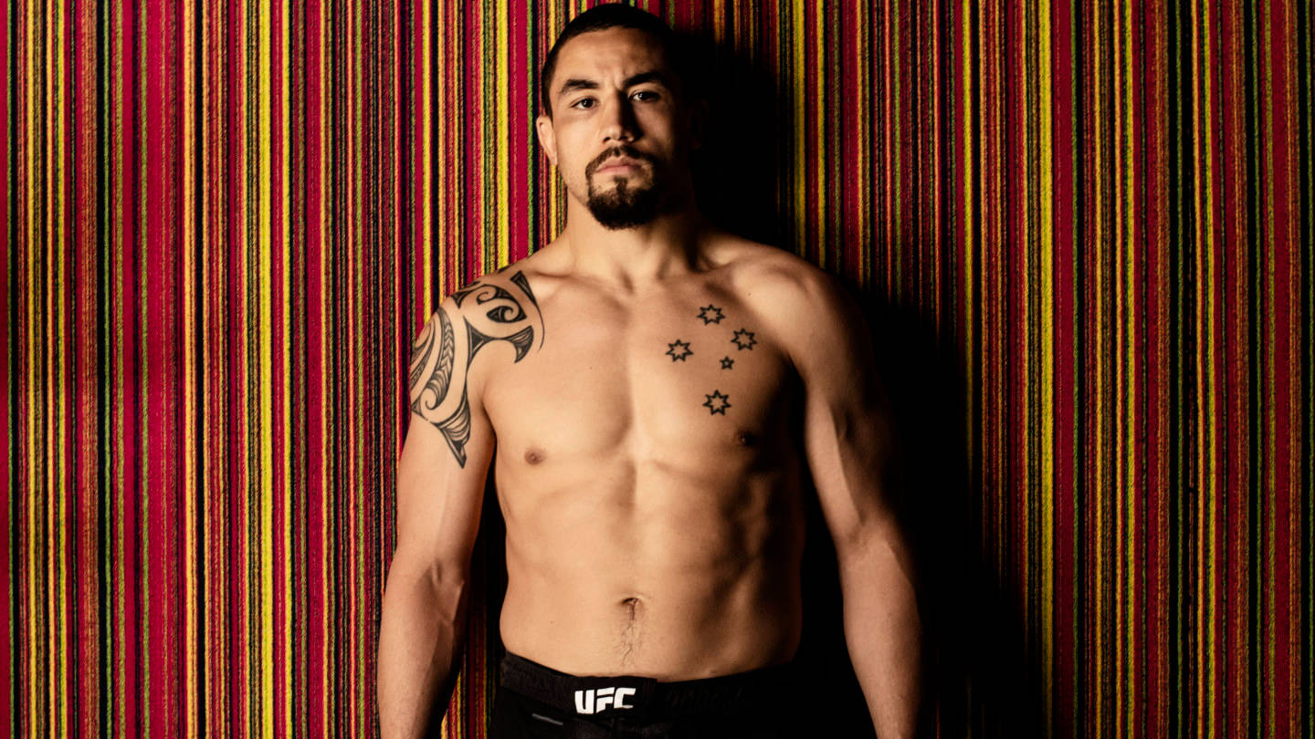 Robert Whittaker Against Colorful Striped Wall Wallpaper
