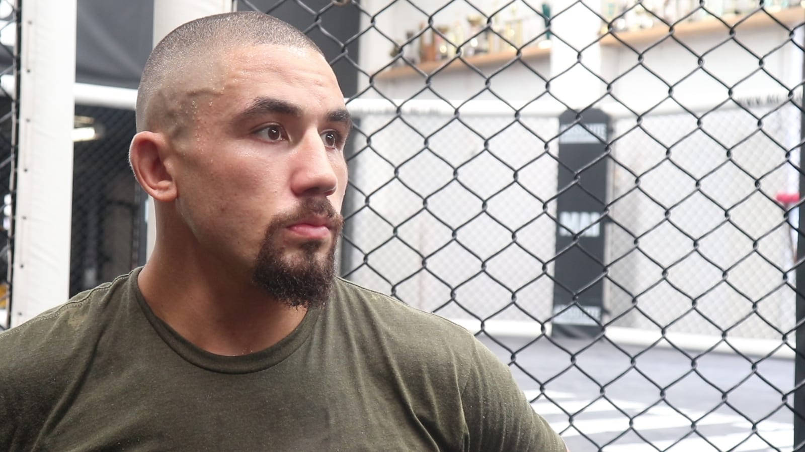 Robert Whittaker Against Octagon Cage Wallpaper