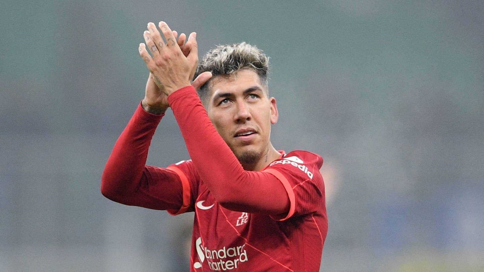 Liverpool Striker Roberto Firmino Applauding on the Pitch Wallpaper