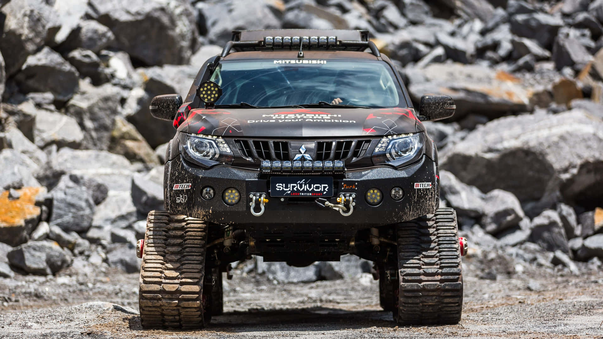 Robust Mitsubishi Triton Advancing Rough Terrains Wallpaper