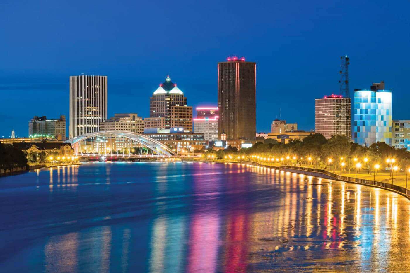 Download Rochester Skyline Night Reflections Wallpaper | Wallpapers.com