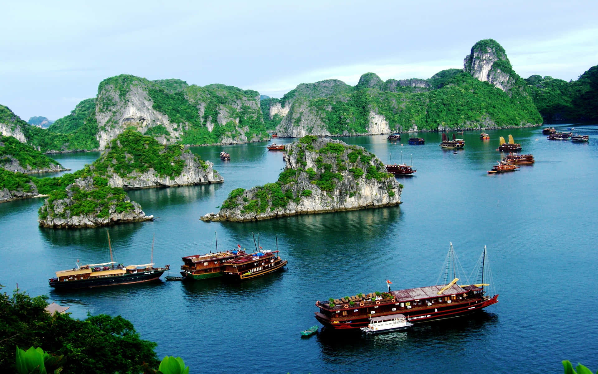 Rock Formations And Ships In Halong Bay Wallpaper