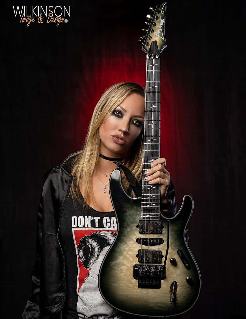 Rock Guitaristwith Black Electric Guitar Wallpaper