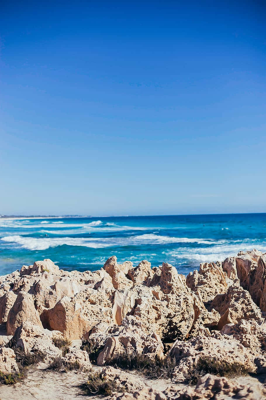 Rocky Beachfront Blue Waters Wallpaper