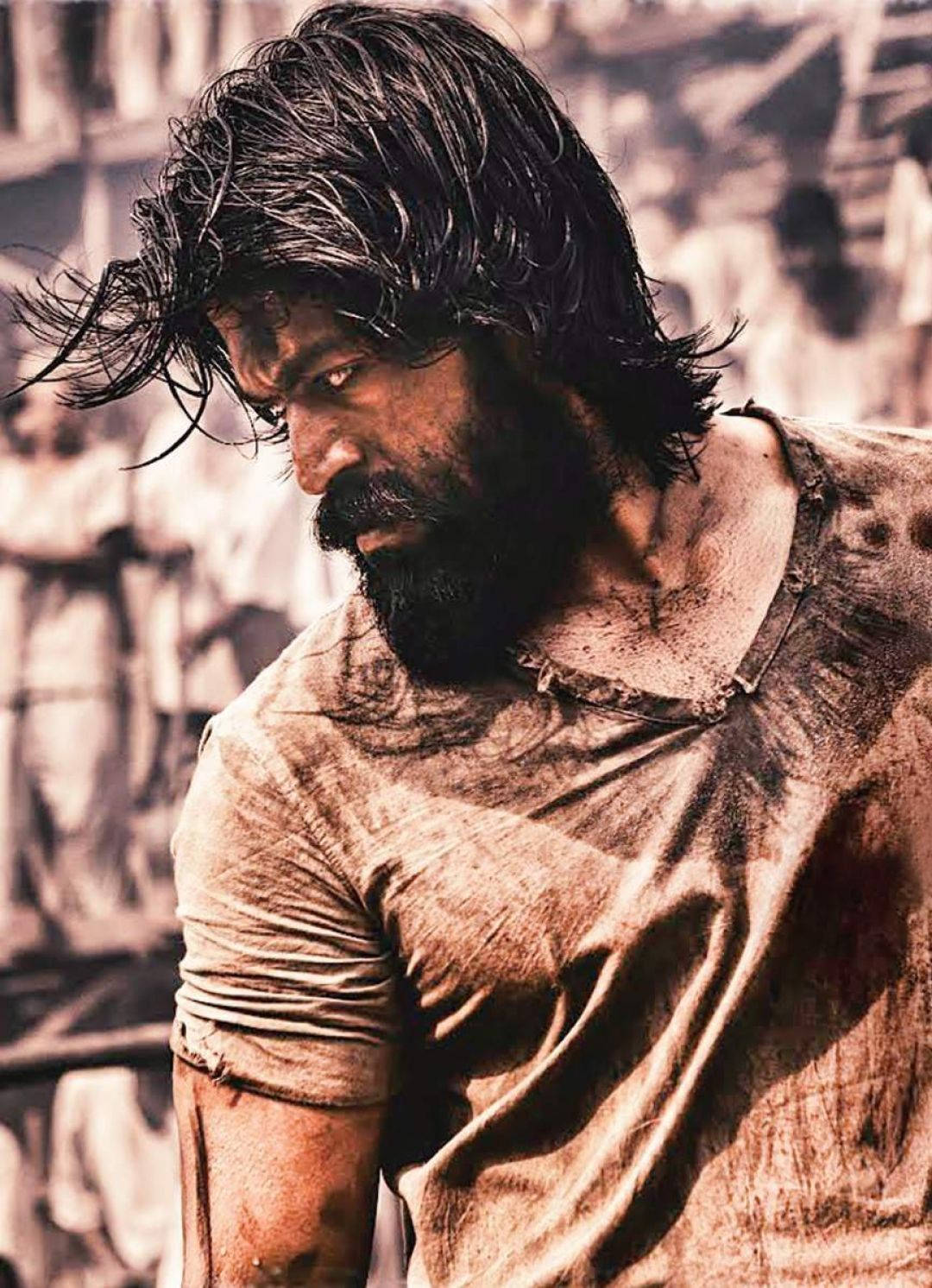 Rocky Bhai showcasing his signature rugged look with a fierce beard and intense eyes. Wallpaper