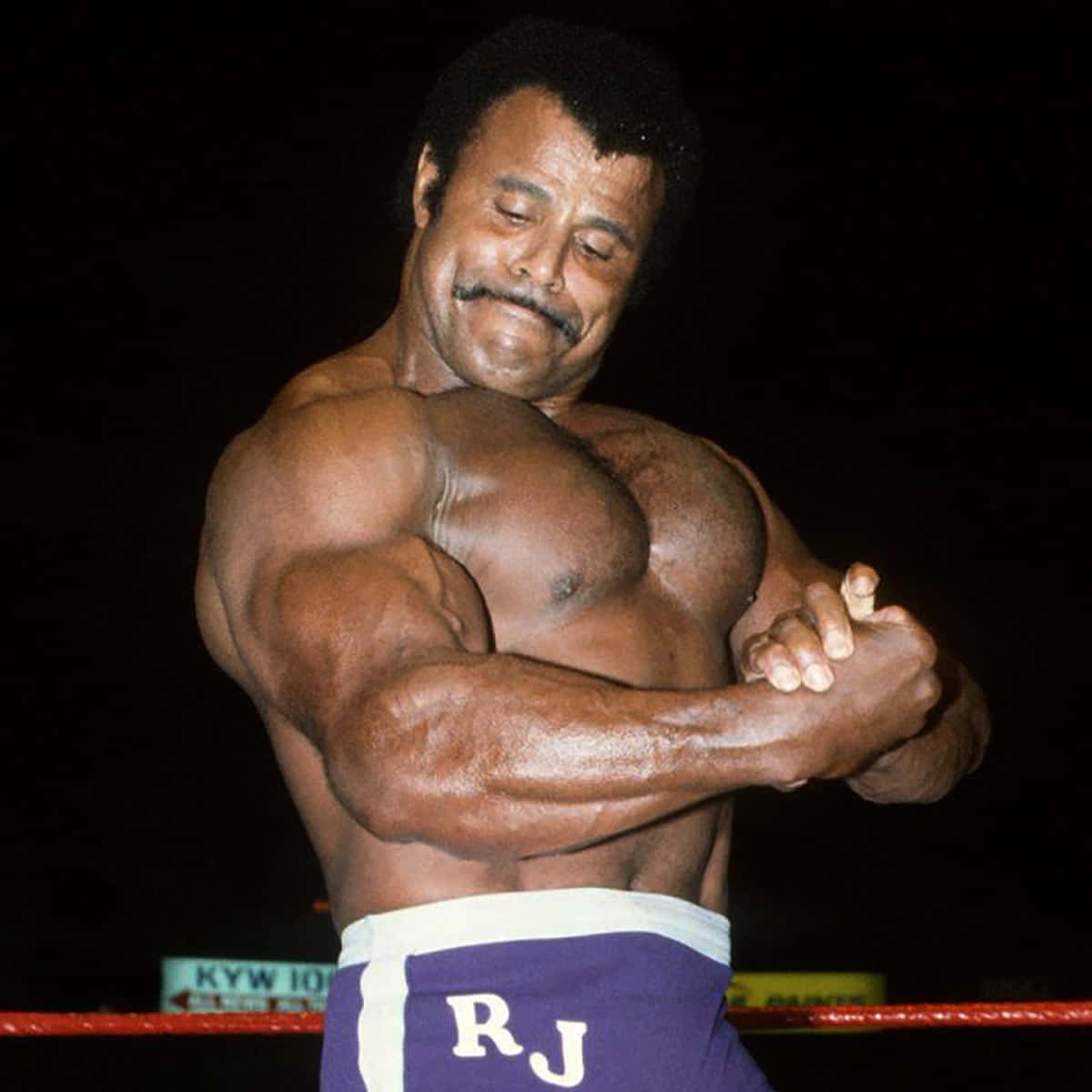 Rocky Johnson Flexing His Arm Inside The Ring Wallpaper