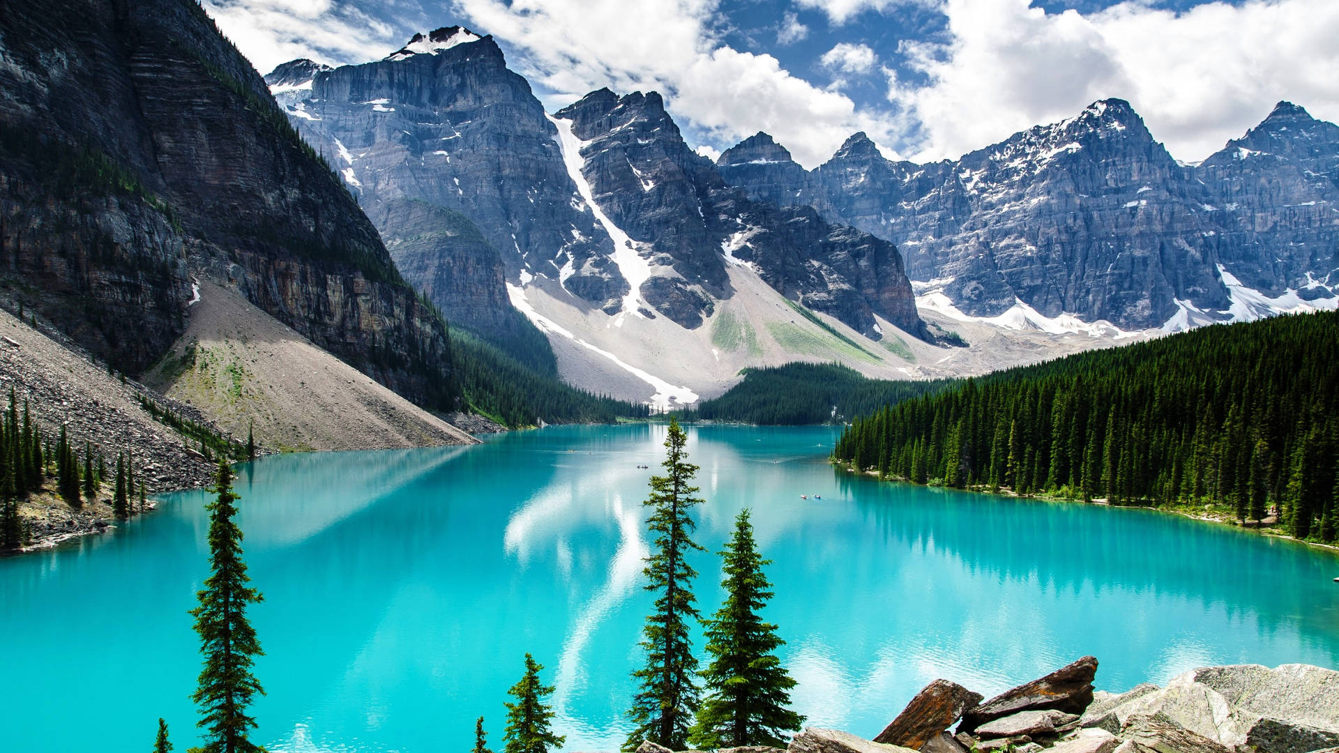 Rocky Mountain With Forest Surrounding Body Of Water Wallpaper