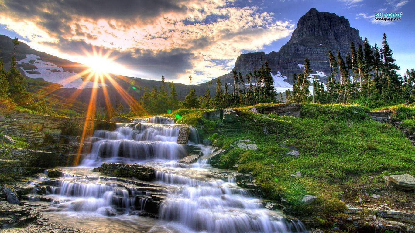 Rocky Mountain With Grassy Waterfall Wallpaper