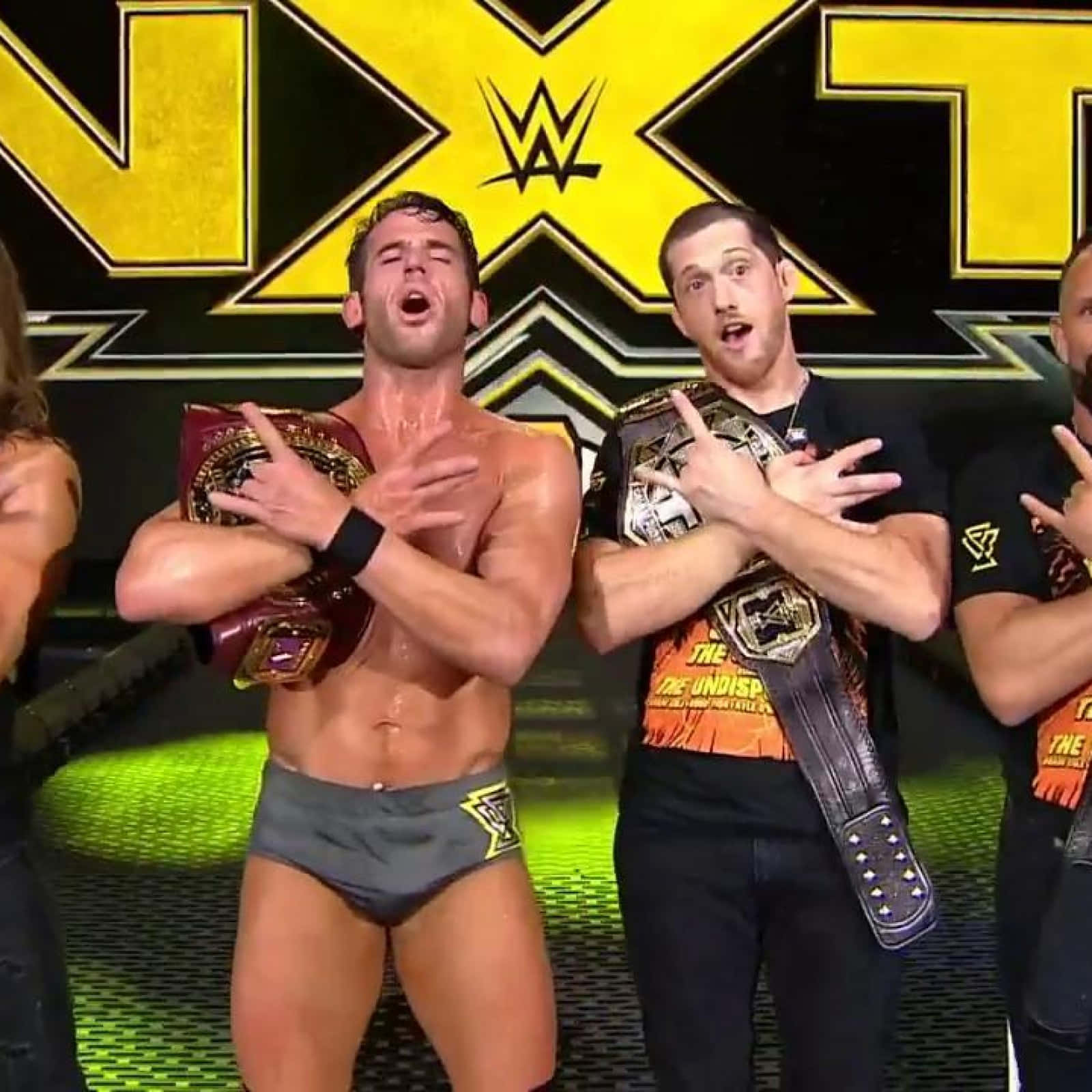 Roderick Strong making the iconic rock sign during a wrestling event Wallpaper