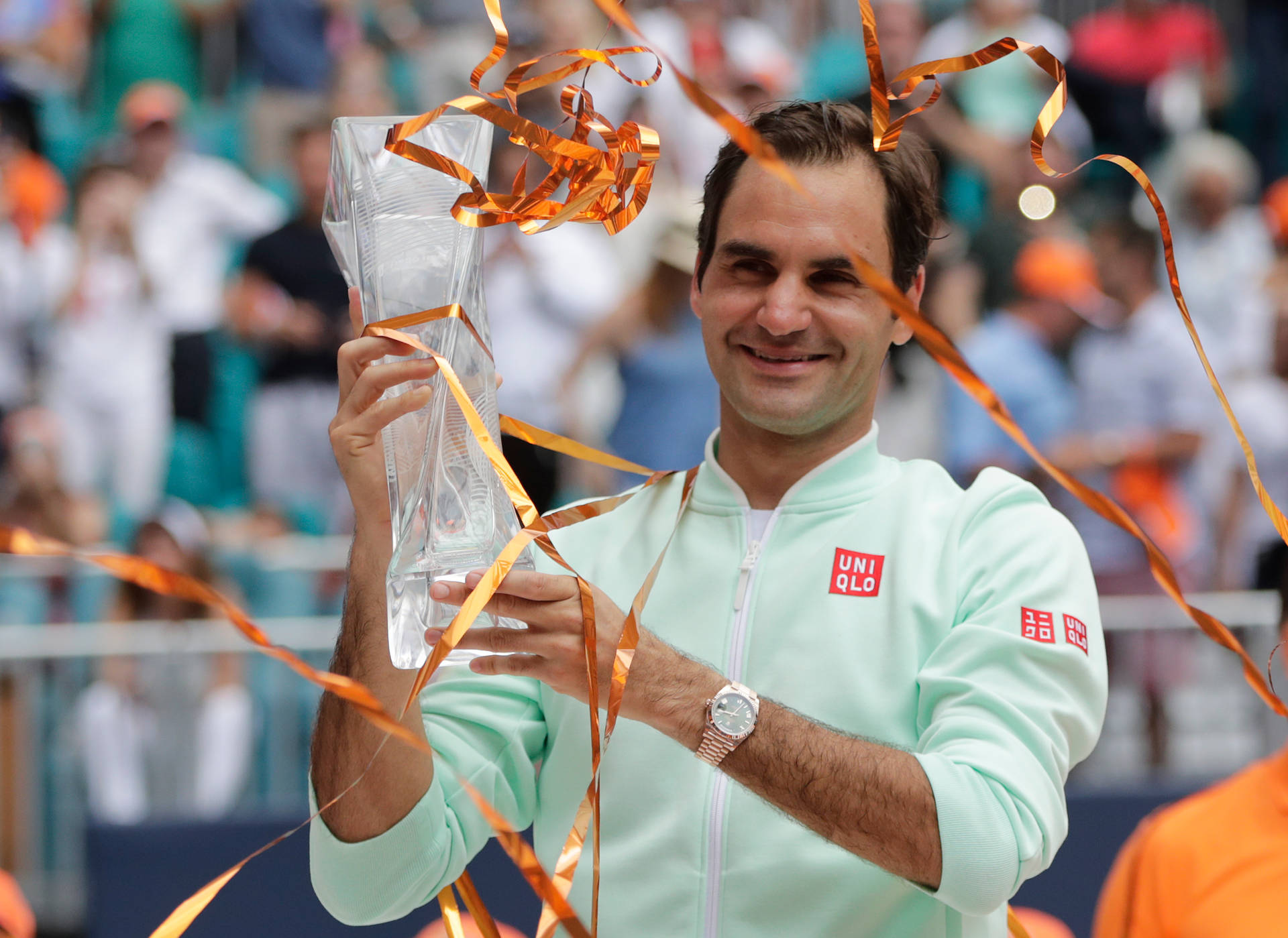 Roger Federer Triumphantly Holding a Crystal Trophy Wallpaper