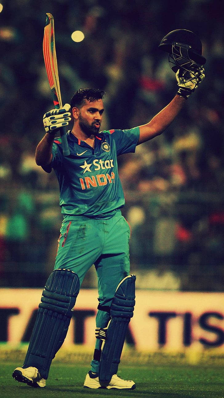 Rohit Sharma i grøn cricket uniform pryder tapetet. Wallpaper