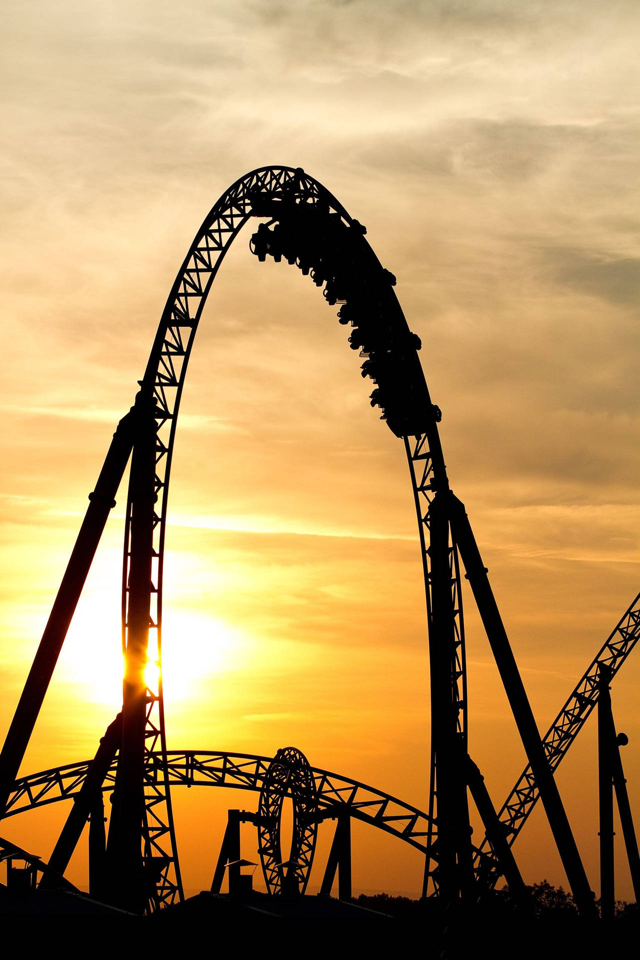 Captivating Silhouette of Arching Roller Coaster Wallpaper