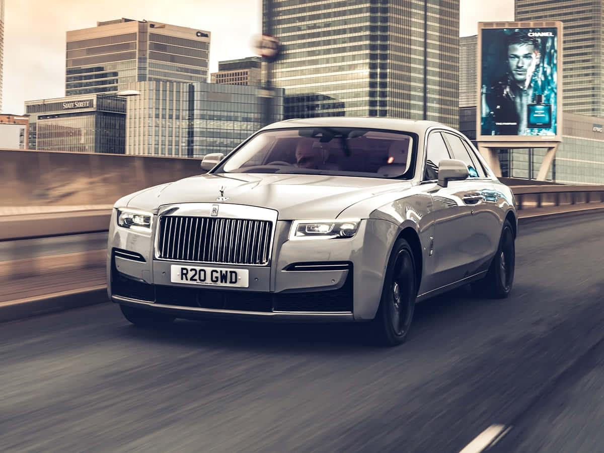 Luxurious Rolls-Royce Cruising Down a Picturesque Road