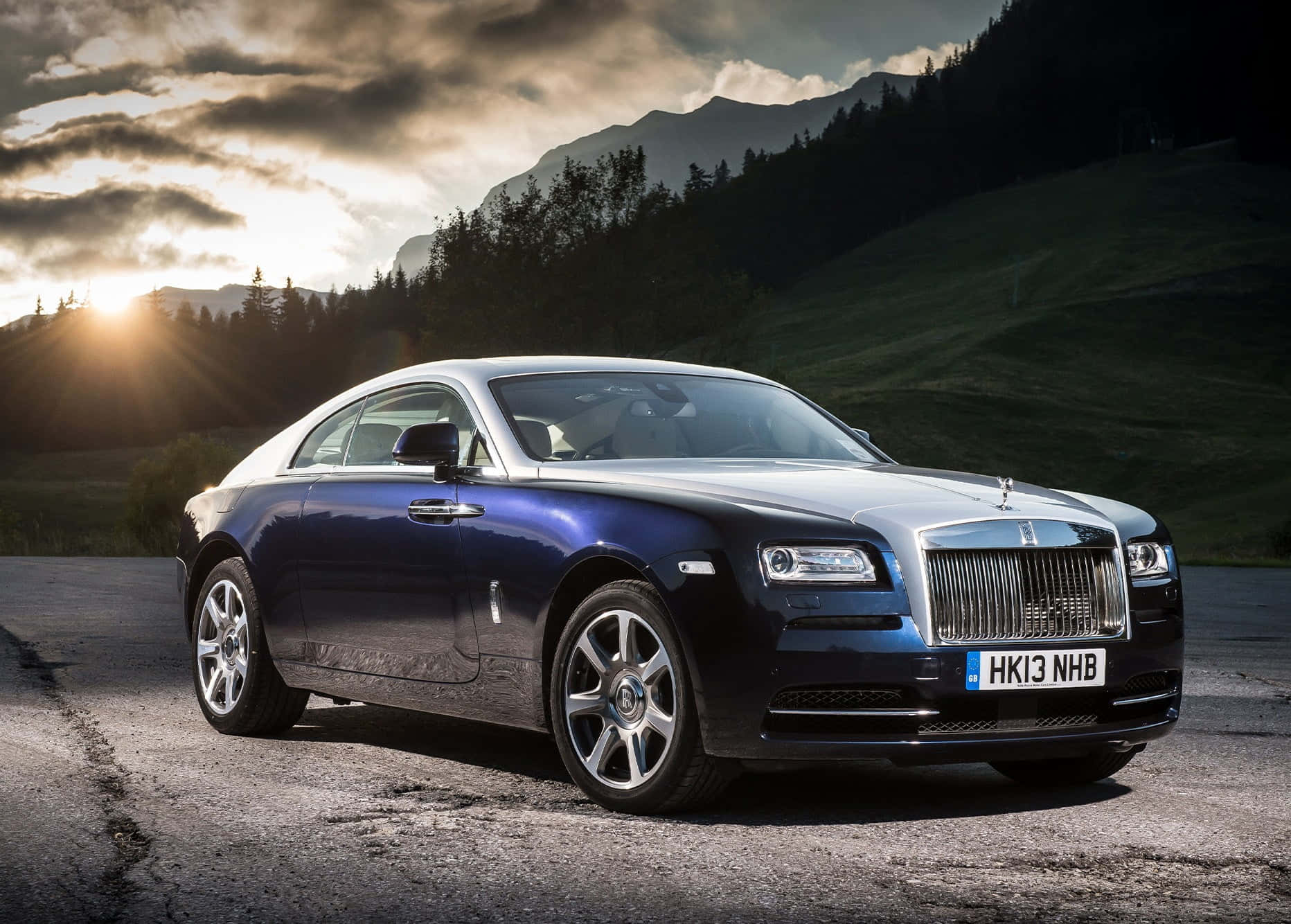 Luxury Rolls Royce on display in dramatic lighting