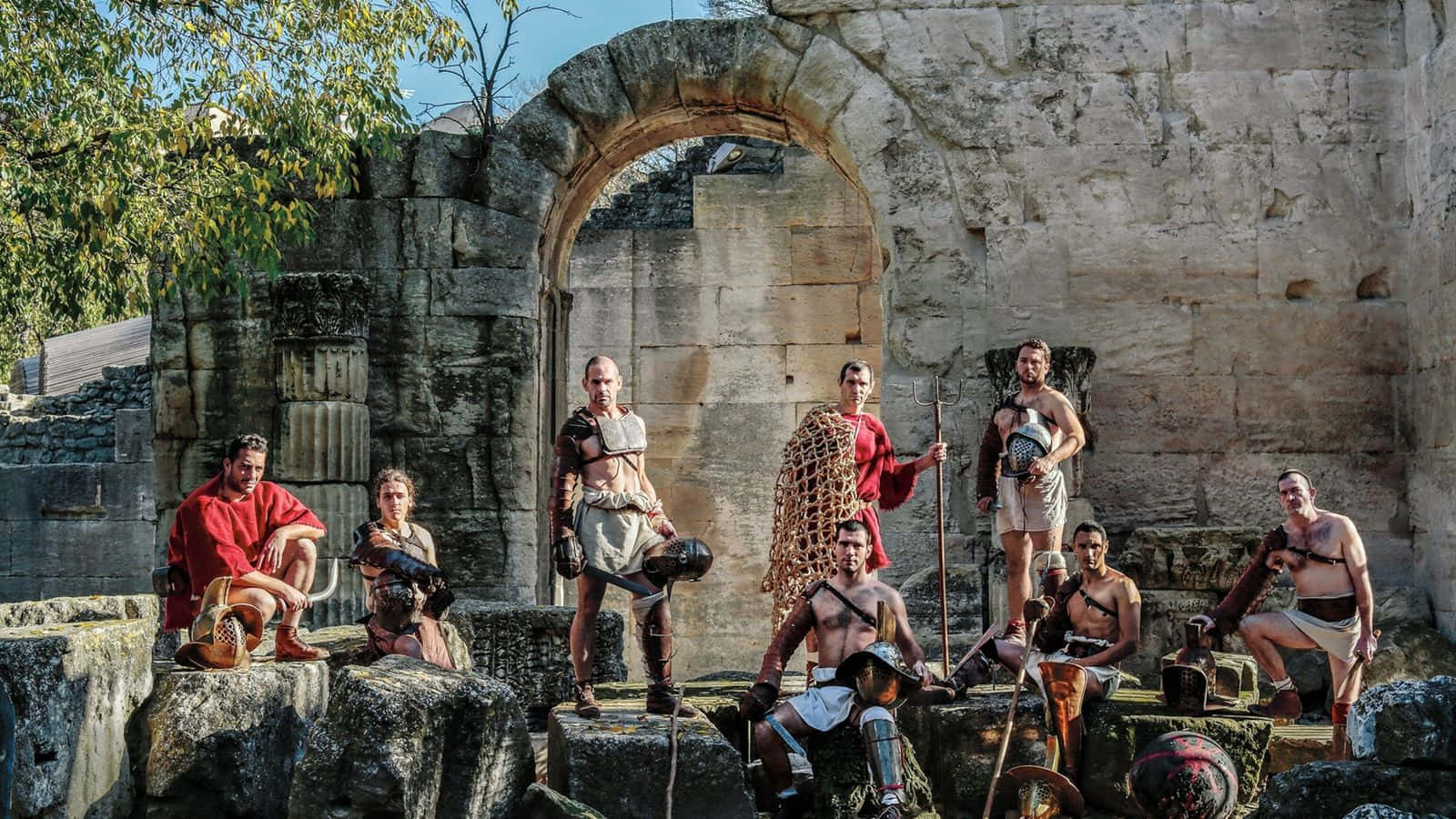 A Group Of People Posing In Front Of An Ancient Building