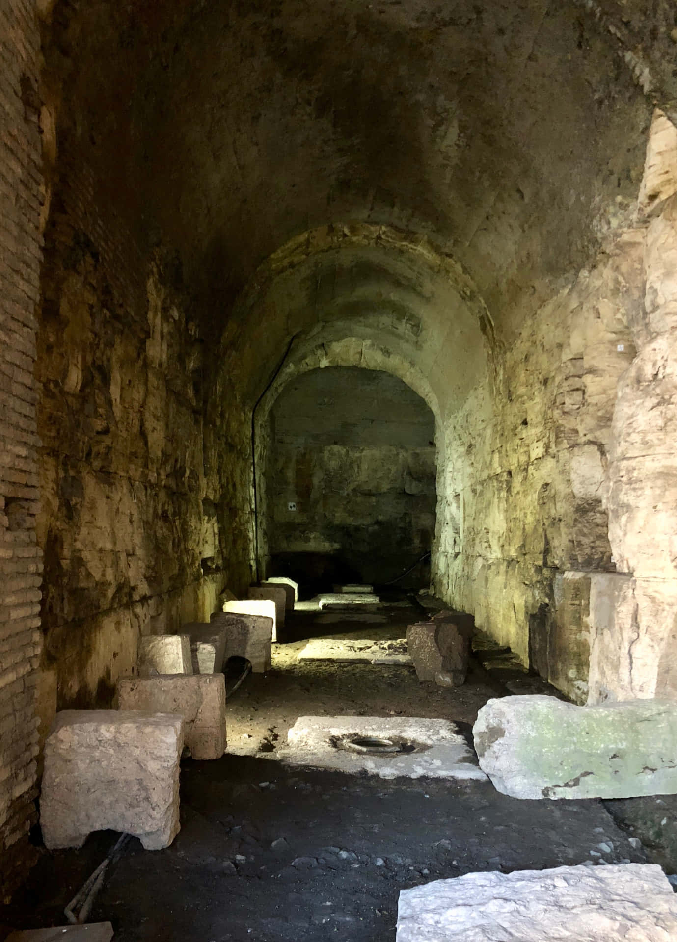 A Tunnel With Stones And A Stone Bench