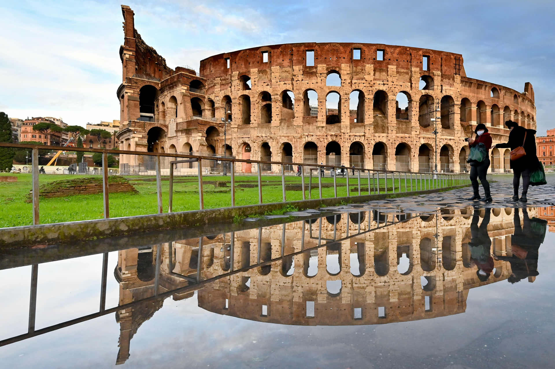 A Couple Is Standing In Front Of The Colossion