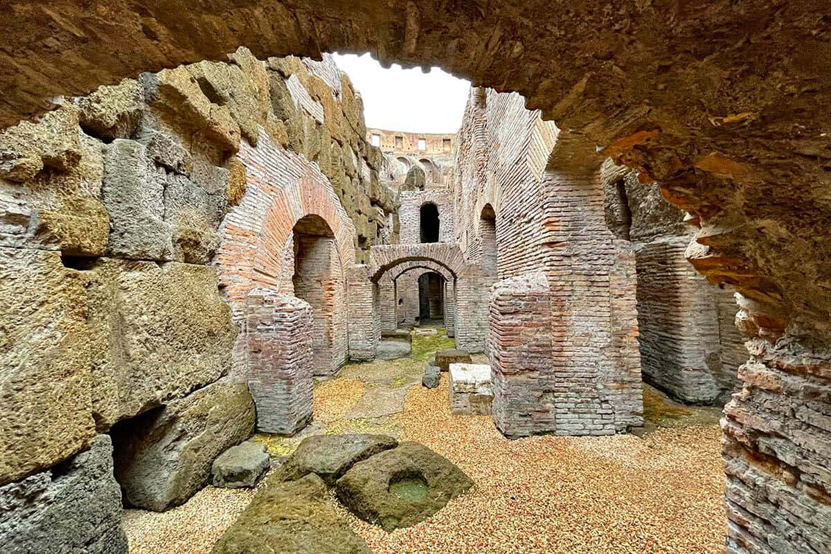 A Small Archway With Stones And A Stone Wall