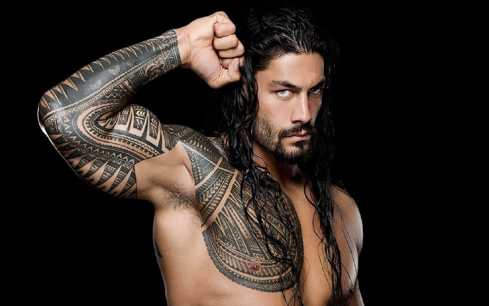 Wwe Wrestler With Tattoos Posing With His Arms Raised