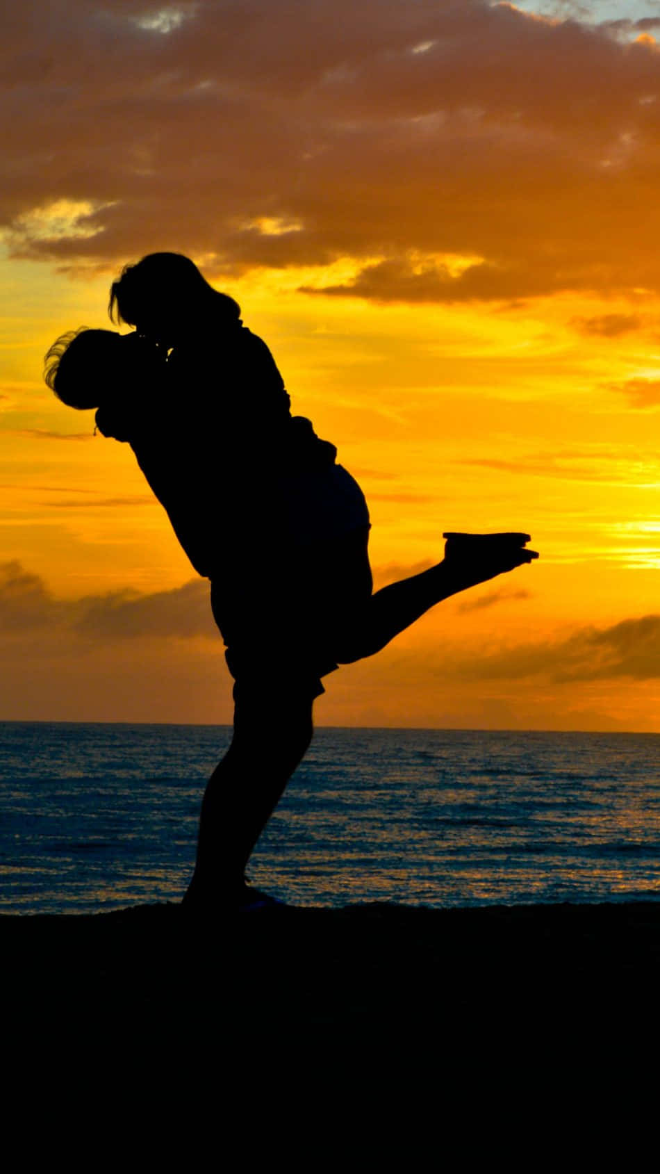 Glücklichespaar Küsst Sich Vor Romantischer Kulisse Des Sonnenuntergangs Am Strand.